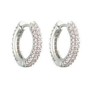 Detail of silver huggie hoop earrings featuring pink cubic zirconia pavé stones