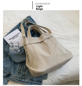 Detail view of light beige nylon tote bag with adjustable strap and spacious design