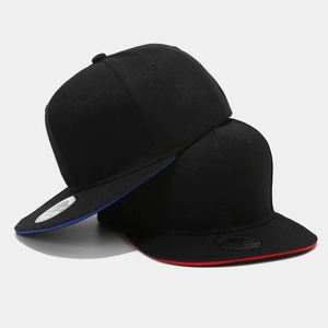 Black snapback hats with blue and red sandwich brim details and sport cap stickers