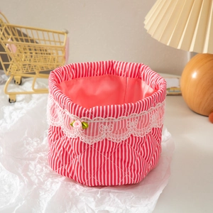 Quilted fabric organizer basket in red and white vertical stripes with lace trim