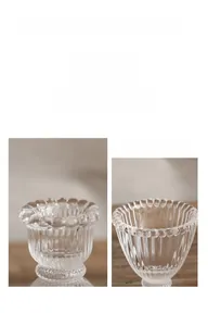 Detail of ribbed glass candle holder with decorative beaded rim and vertical texture