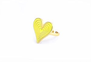 Detail of yellow enamel heart ring showing polished gold plating and concentric design