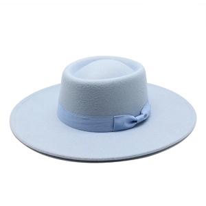 Close-up of light blue wool fedora hat featuring a matching ribbon bow and wide flat brim
