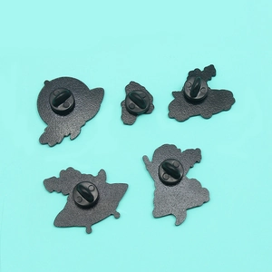 Back view of five cartoon enamel pins showing the black rubber butterfly clutch backs