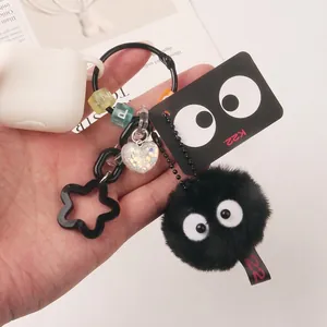 Black soot sprite plush keychain with colorful charms and white earphone case