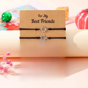 Detailed view of friendship bracelets set with sun moon star charms on message card