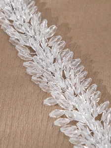 Close-up of intricate hand-beaded crystal leaf vine for bridal hair accessories