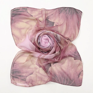 Detail view of purple-pink lotus pattern chiffon scarf folded into a floral shape