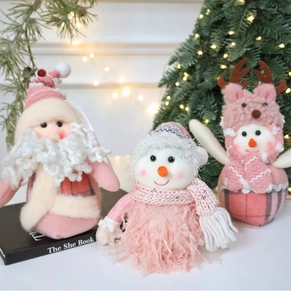 Detailed view of pink plush Santa, elk and snowman figures for Christmas decor