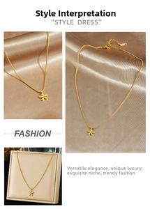 Macro view of gold flower pendant necklace on silk with box chain and lobster clasp
