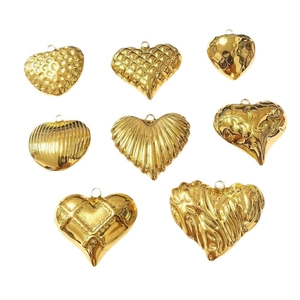 Golden titanium steel heart pendants with various 3D embossed textures on white background