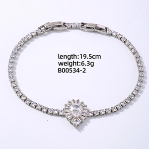 Detailed view of silver tennis bracelet with pear-shaped zircon and halo setting