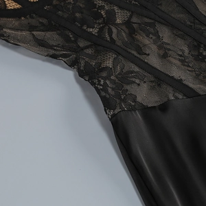 Detail of floral black lace and satin fabric on elegant evening gown with fine stitching