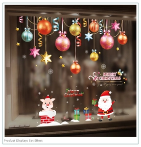 Detail view of festive Christmas glass window stickers with colorful baubles and Santa