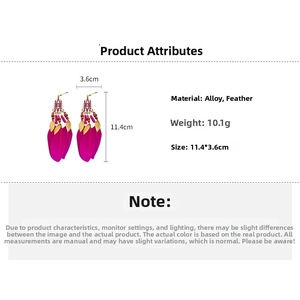 Detail view of Bohemian rose red feather earrings with gold leaf and bead accents