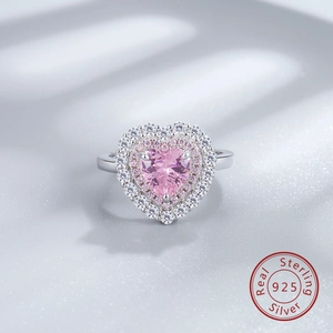 Macro detail of S925 sterling silver ring with heart-shaped pink diamond and pave crystals