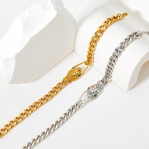 Snake head cuban link bracelet with green stone eyes in gold and silver finishes