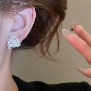 Close-up of geometric triangle stud earring with white pearls and sparkling zircons