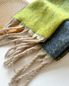Detail of yellow and blue plaid scarf with soft fringe on a woven tray