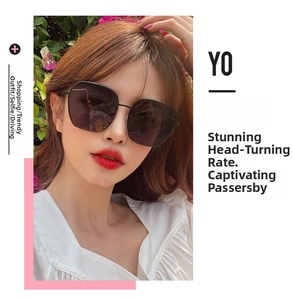 Detail of oversized square sunglasses featuring elegant metal frames on model