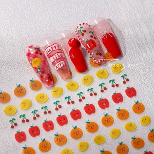 Close-up of fruit themed nail stickers with cute apple and cherry patterns
