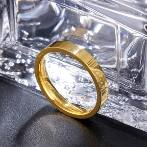 Detailed close-up of 3mm gold titanium steel ring with polished mirror finish texture
