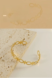 Close-up of gold hollow cross and oval link bracelet made of durable stainless steel