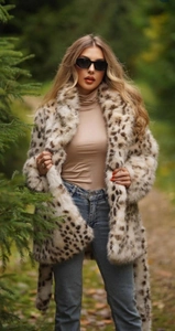 Outdoor shot showing high-quality leopard faux fur texture and beige knit layering