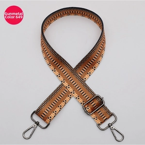 Detail of 38mm wide woven bag strap with geometric patterns and gunmetal hardware
