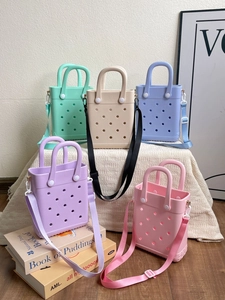 Close-up of colorful EVA tote bags with perforated texture and detachable straps