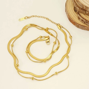 Detail of 18K gold-plated double-layer snake and bead chain necklace in stainless steel
