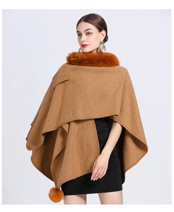Detail of camel faux fur collar and matching pom-poms on a knit poncho cape