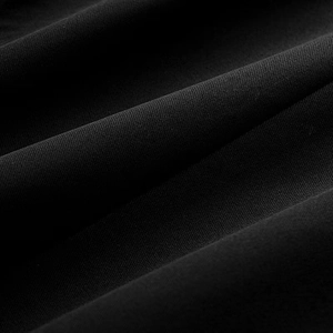 Close-up of black blazer fabric showing detailed twill weave texture and high quality fiber