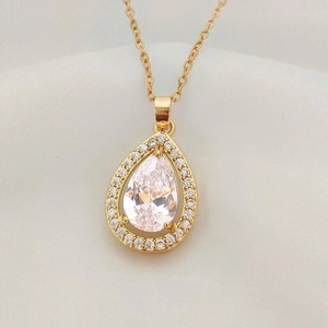 Elegant gold pear cut drop pendant necklace with shimmering zircon stones and halo design
