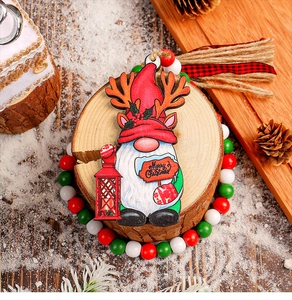 Macro view of Christmas gnome wooden ornament with wood beads and Merry Christmas sign