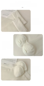 Detail of white ribbed socks showing reinforced toe, elastic cuff, and knit texture