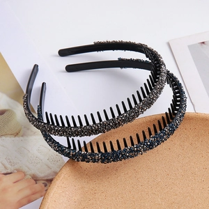 Sparkling rhinestone non-slip headbands with teeth in blue and silver on a wooden tray