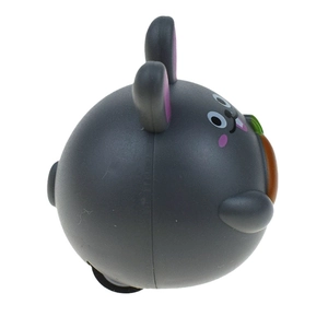 Detailed view of a dark grey bunny pull-back car holding an orange carrot toy