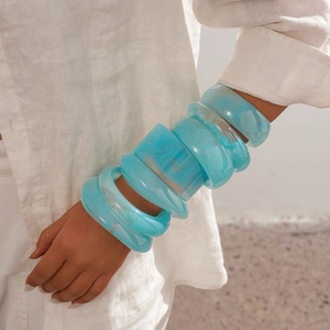 Close-up of resin marble effect bracelets in aqua blue on model wrist