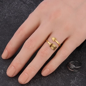 Detail of adjustable arrow-shaped ring in gold and silver finish on hand