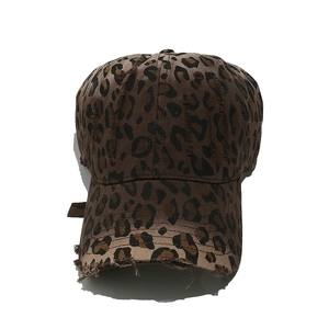 Detailed close-up of distressed leopard print baseball cap with frayed edge details