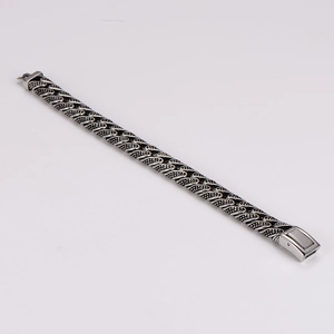 Detail of retro braided stainless steel bracelet with silver and black textured finish