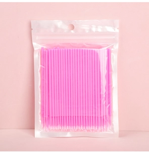 Pink micro brushes for eyelash extension and permanent makeup in clear plastic bag
