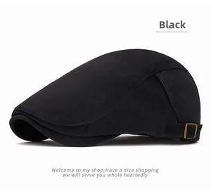 Detail view of adjustable metal buckle on a black vintage newsboy cap with brushed texture