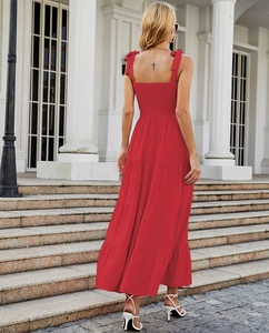 Detailed back view of a red floral maxi dress featuring tie-up straps and an open back design