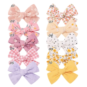 10-piece set of handmade fabric bow hair clips with assorted floral and polka dot patterns