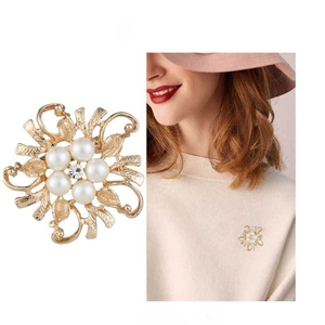 Detail of gold flower brooch with white pearls and rhinestone including model view