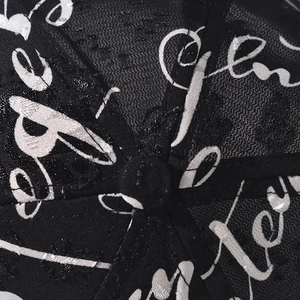 Close-up of breathable mesh fabric and artistic script print on a six-panel baseball cap