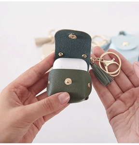 Mini PU leather AirPods case with wrist strap and gold metal clasp in dark green