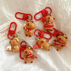 Cute Capybara cartoon keychains set featuring sports and music themes with red lobster clasps